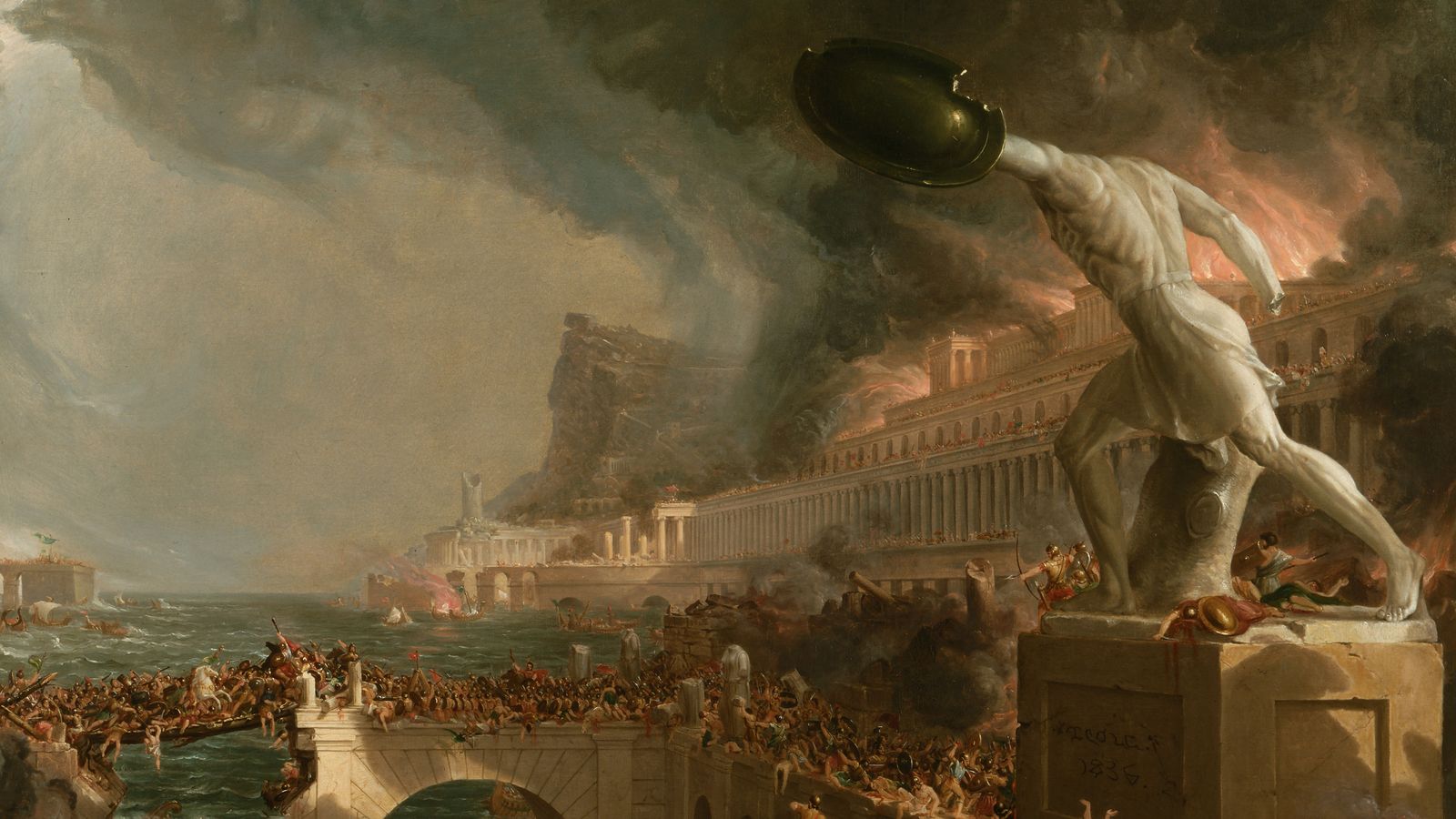 A burning classical city under attack, with a huge headless statue holding up a shield in the foreground